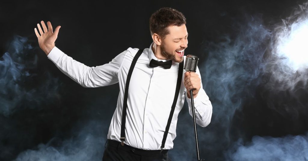 Male singer enjoying his performance now that he has done his voice exercises.